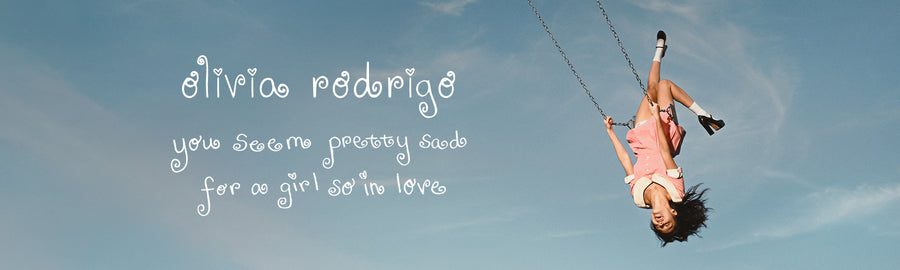 Person on a swing with text overlay against a blue sky