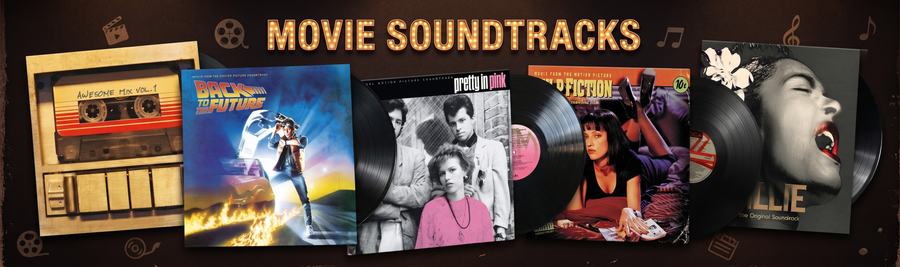 Movie soundtracks and music memorabilia including a cassette tape, vinyl records, and movie posters on a dark background.